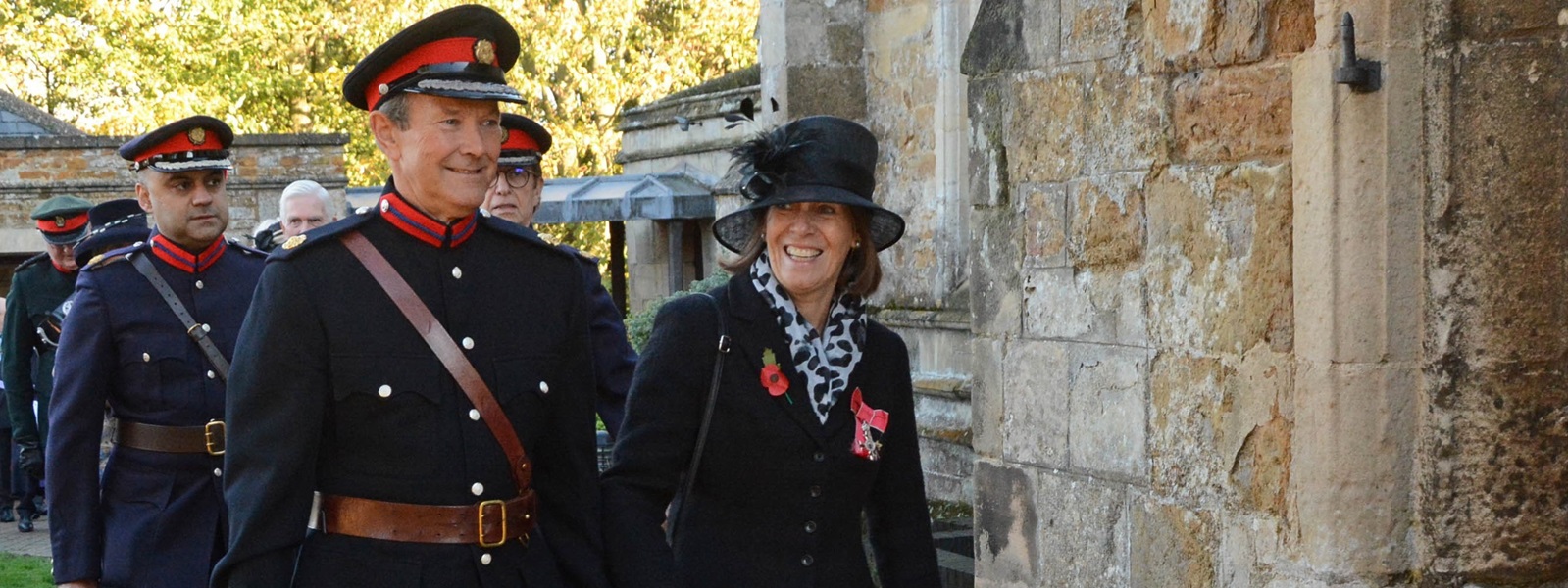 The deputy lieutenants walking towards an entrance to attend a ceremony