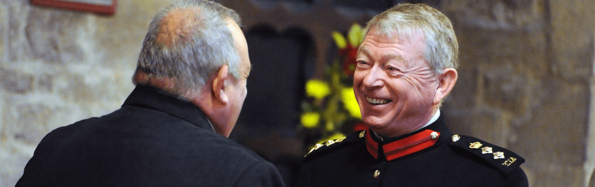 The Vice Lord-Lieutenant, Colonel Richard Hurwood DL, standing in front of St Mary's Church, Melton and smiling