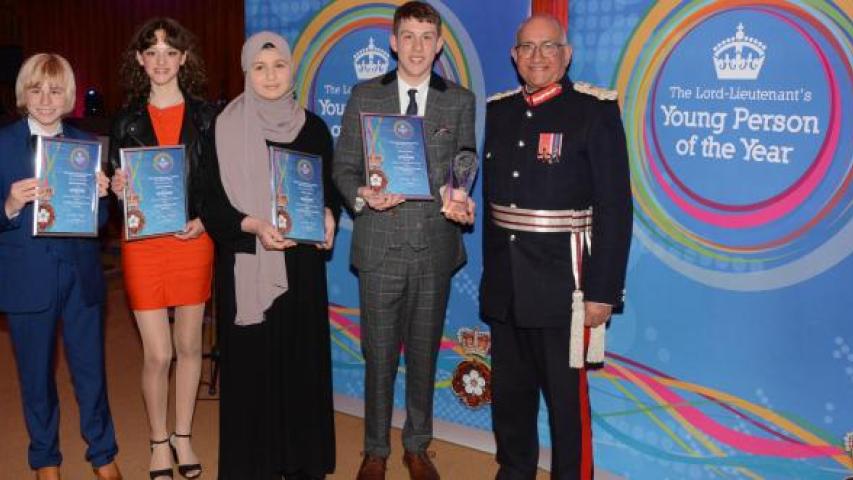 Lord Lieutenant's award for young people 2023 finalists standing with the Lord-Lieutenant holding their awards 